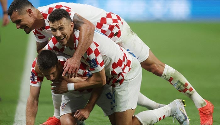 Soccer Football - FIFA World Cup Qatar 2022 - Group F - Croatia v Canada - Khalifa International Stadium, Doha, Qatar - November 27, 2022 Croatias Andrej Kramaric celebrates scoring their third goal with teammates Ivan Perisic and Dejan Lovren. — Reuters