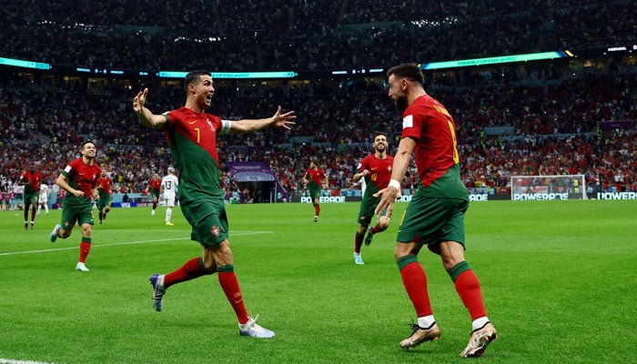 Portugals Cristiano Ronaldo celebrates scoring their first goal with Bruno Fernandes. REUTERS