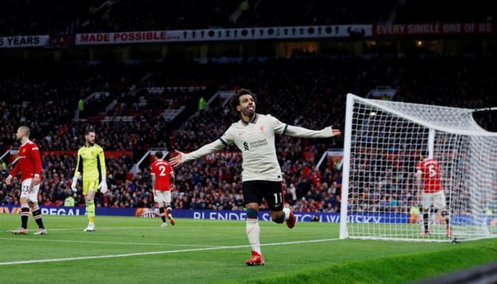 Liverpools Egyptian midfielder Mohamed Salah celebrates after scoring their fifth goal, his third during a match between Manchester United and Liverpool.— AFP