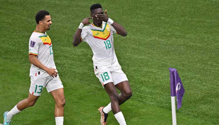 Senegal’s forward #18 Ismaila Sarr celebrates with Senegal´s forward #13 Iliman Ndiaye after scoring his team’s first goal from the penalty spot during the Qatar 2022 World Cup Group A football match between Ecuador and Senegal at the Khalifa International Stadium in Doha on November 29, 2022. —AFP