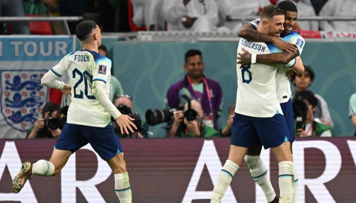 Englands Marcus Rashford (R) celebrates with Englands midfielder Jordan Henderson and Englands Phil Foden after scoring his teams third goal during the Qatar 2022 World Cup Group B football match between Wales and England at the Ahmad Bin Ali Stadium in Al-Rayyan, west of Doha on November 29, 2022. AFP