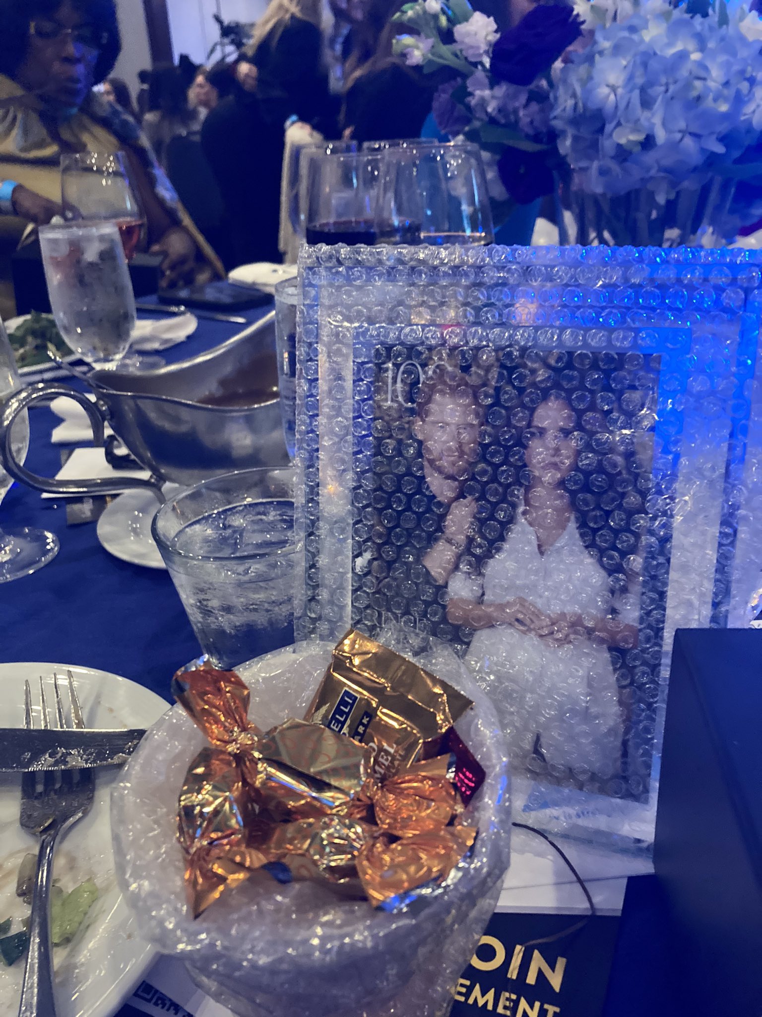 Meghan Markle mocked after her framed photos with Harry placed at tables during Charity event