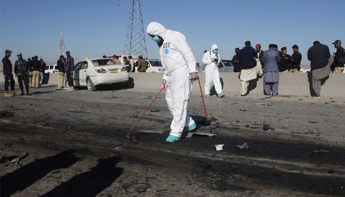 A member of a crime scene unit surveys the site after a suicide bomb blast on a police patrol in Quetta, November 30, 2022. — Reuters