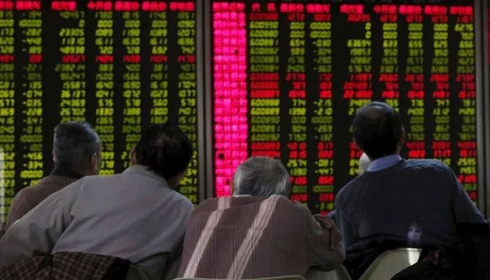 A group of stockbrokers is glued to a trading screen at Pakistan Stock Exchange. — Reuters/File