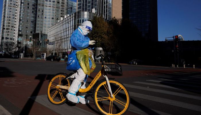 A health worker in a protective suit waits at a traffic light in a street in the central business district (CBD) that is largely deserted because of work-from-home orders as coronavirus disease (COVID-19) outbreaks continue in Beijing, China November 30, 2022.— Reuters