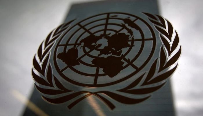 The United Nations headquarters building is pictured though a window with the UN logo in the foreground in the Manhattan borough of New York August 15, 2014.— Reuters