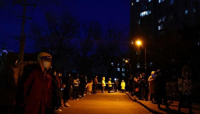 People line up to take a nucleic acid test for the coronavirus disease (COVID-19), near a residential compound in Beijing, China December 3, 2022. — Reuters