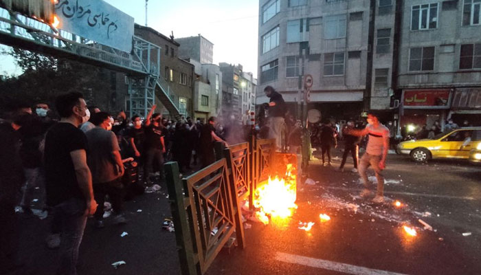 People light a fire during a protest over the death of Mahsa Amini, a woman who died after being arrested by the Islamic republics morality police, in Tehran, Iran September 21, 2022. WANA (West Asia News Agency) via REUTERS