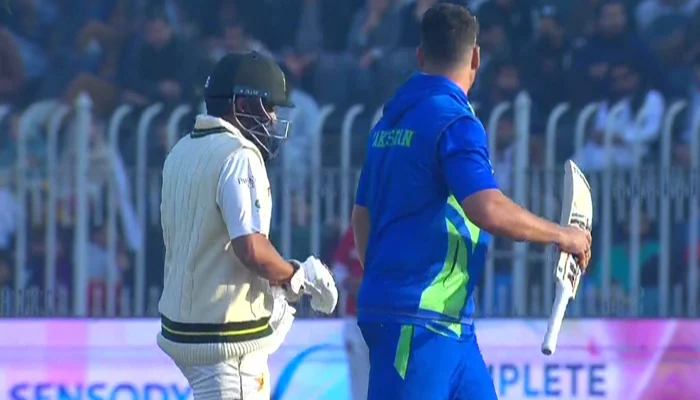 Azhar Ali walks off the field with the physio during the fourth day of the first Test between Pakistan and England at the Pindi Cricket Stadium, on December 4, 2022. — PTV Sports Screengrab