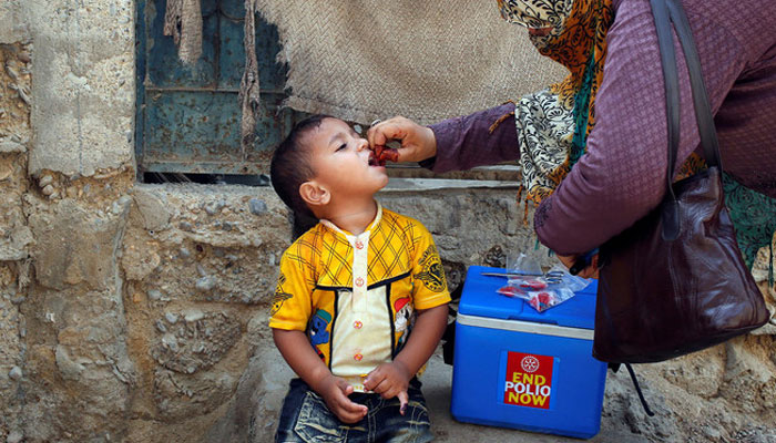 A boy receives polio vaccine drops during an anti-polio campaign in a low-income neighbourhood in Karachi, Pakistan, on April 9, 2018. — Reuters