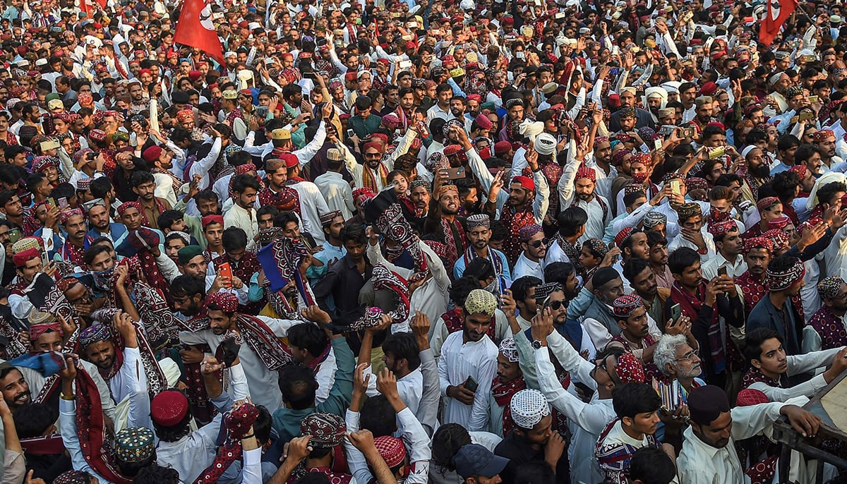 People wearing traditional Sindhi attire celebrate during a Sindh Cultural day festival in Karachi on December 4, 2022. — AFP