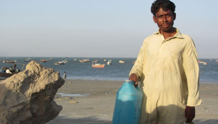 A fisherman holds a jerry can of drinking water near Pakistans Arabian Sea port of Gwadar, April 1, 2018.Thomson Reuters Foundation/Rina Saeed Khan