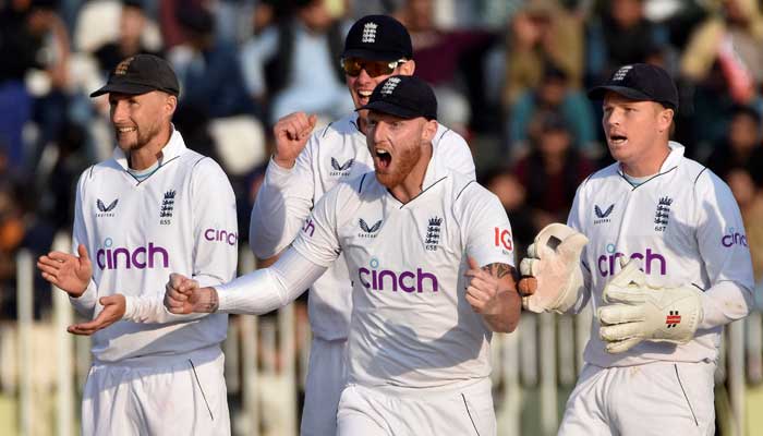 Englands players celebrate the dismissal of Pakistans Agha Salman at the Pindi cricket stadium on December 5, 2022. — Reuters