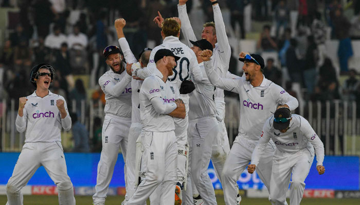 England’s players celebrate after their victory at the end of the fifth and final day of the first cricket Test match between Pakistan and England at the Rawalpindi Cricket Stadium. — AFP