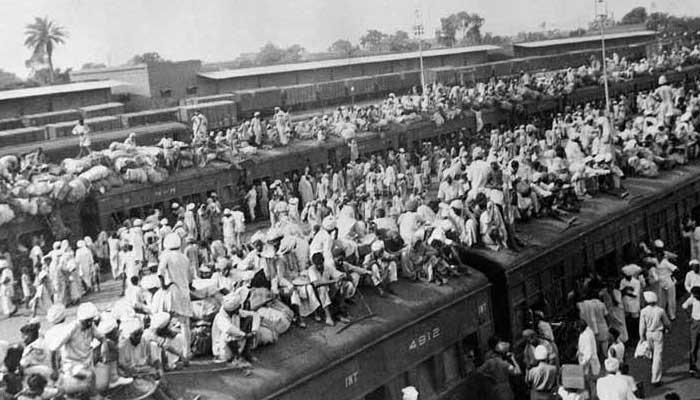 A file photograph of Partition refugees sitting on and stepping into a train on October 15, 1947. —AFP