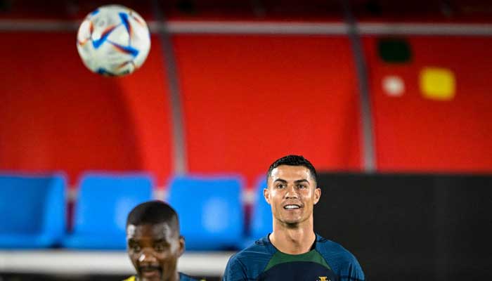 Portugals forward Cristiano Ronaldo (R) and Portugals midfielder William Carvalho (L) take part with his teammates in a training session at Shahaniya Sports Club of Al Samriya Autograph Collection Hotel in Al Samriya, northwest of Doha on December 4, 2022 during the Qatar 2022 World Cup football tournament. — AFP