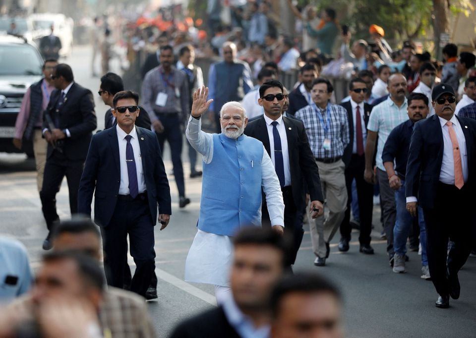 Indias Prime Minister Narendra Modi waves to his supporters as he arrives to cast his vote during the second and last phase of Gujarat state assembly elections in Ahmedabad, India, December 5, 2022.— Reuters