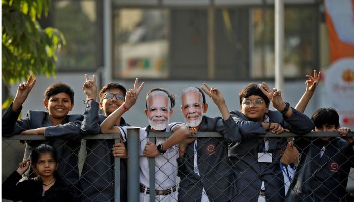 School children gesture towards Indias Prime Minister Narendra Modi as he arrives to cast his vote during the second and last phase of Gujarat state assembly elections in Ahmedabad, India, December 5, 2022.— Reuters