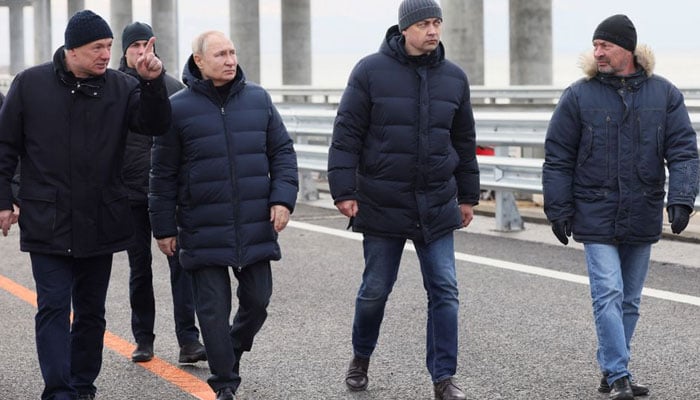 Russian President Vladimir Putin listens to Deputy Prime Minister Marat Khusnullin as he visits a bridge connecting the Russian mainland with the Crimean Peninsula across the Kerch Strait, December 5, 2022. Sputnik/Mikhail Metzel/Pool via REUTERS