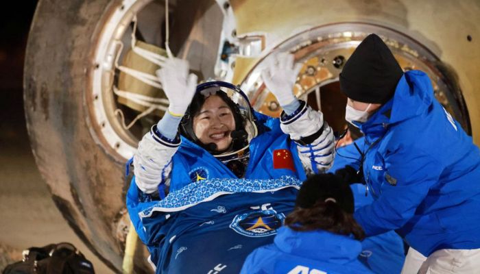 Astronaut Liu Yang waves as she is out of a return capsule of the Shenzhou-14 spacecraft, following a six-month mission on Chinas space station, at the Dongfeng landing site in Inner Mongolia Autonomous Region, China December 4, 2022.— AFP