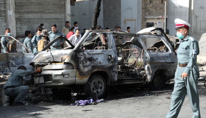 Afghan security forces inspect the wreckage of a passenger van after a blast in Kabul, Afghanistan.— Reuters/File