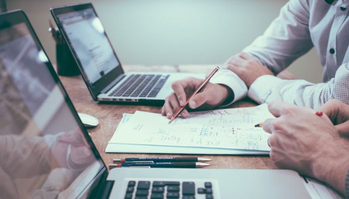 Two colleagues brainstorming over paper.— Unsplash