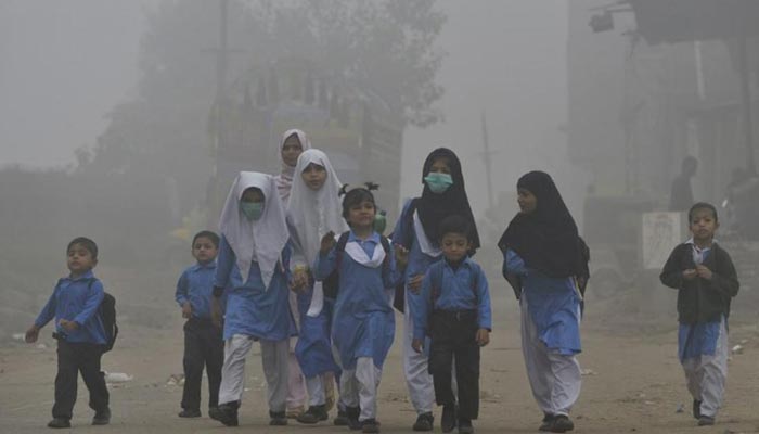 Children walking to school in heavy smog in Lahore, Pakistan, November 6, 2017. — AFP/File