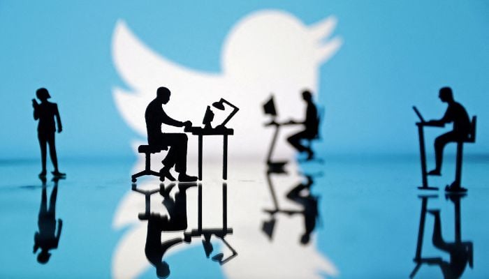 Figurines with computers and smartphones are seen in front of Twitter logo in this illustration, July 24, 2022.— Reuters