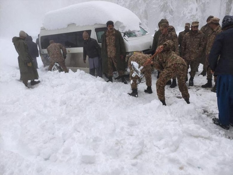 Soldiers clear snow from a road after a heavy snowfall in Murree, Pakistan January 8, 2022.— ISPR via Reuters