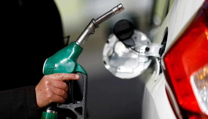 A person filling his fuel tank in this undated photo. — Reuters/File