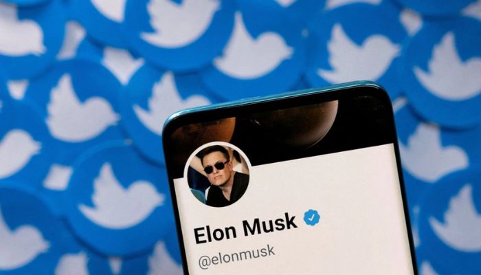 Elon Musks Twitter profile is seen on a smartphone placed on printed Twitter logos in this picture illustration taken April 28, 2022.— Reuters