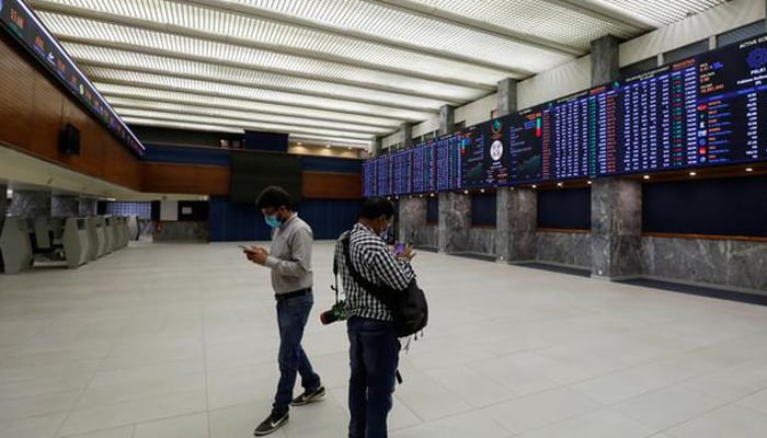 Two men can be seen standing in the main hall of the Pakistan Stock Exchange building in Karachi. — Reuters/File