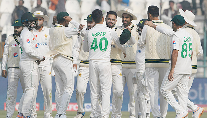 Pakistans Abrar Ahmed (C) celebrates with teammates after taking the wicket of Englands Harry Brook (not pictured) during the first day of the second cricket Test match between Pakistan and England at the Multan Cricket Stadium in Multan on December 9, 2022. — AFP