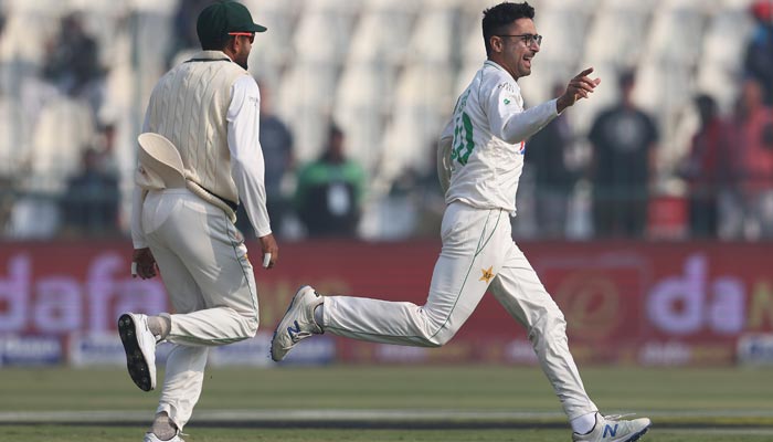 Pakistan skipper Babar Azam (L) and spinner Abrar Ahmed (R) celebrating after taking a wicket against England at the Multan Cricket Stadium on December 9, 2022. — Twitter/ICC