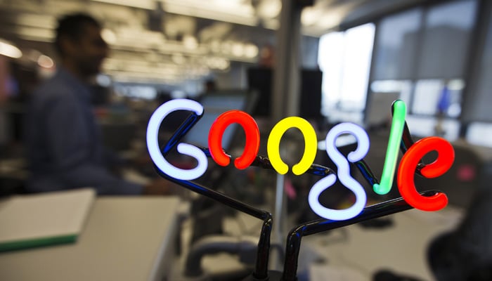 A neon Google logo is seen as employees work at the new Google office in Toronto. — Reuters/File