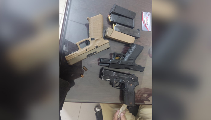 The weapons recovered from the robber after a shootout on Shahrah-e-Faisal in Karachi, on December 9, 2022. — Photo by author