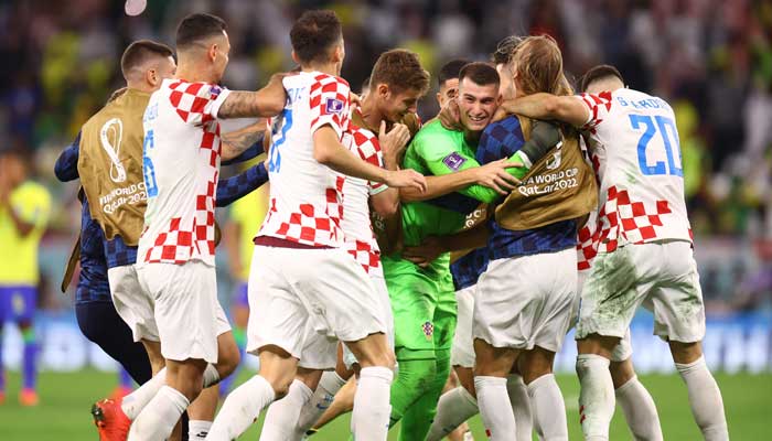 Croatias Dominik Livakovic celebrates with teammates after winning the penalty shootout and qualifying for the semi final. — Reuters