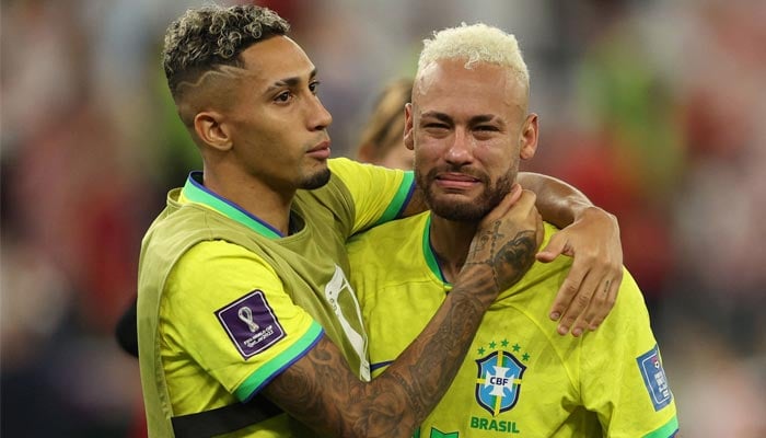 Brazil´s forward #10 Neymar (R) si consoled by Brazil´s forward #11 Raphinha after their team lost the Qatar 2022 World Cup quarter-final football match between Croatia and Brazil at Education City Stadium in Al-Rayyan, west of Doha, on December 9, 2022. — AFP