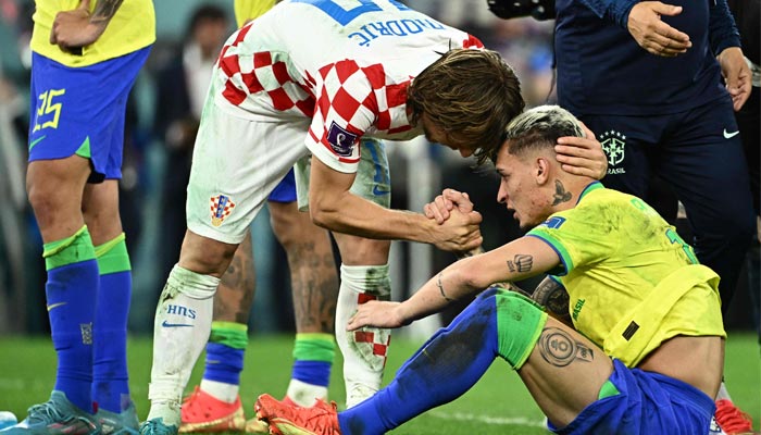 Croatia´s midfielder #10 Luka Modric comforts Brazil´s forward #19 Antony after qualifying to the next round after defeating Brazil in the penalty shoot-out of the Qatar 2022 World Cup quarter-final football match between Croatia and Brazil at Education City Stadium in Al-Rayyan, west of Doha, on December 9, 2022. — AFP