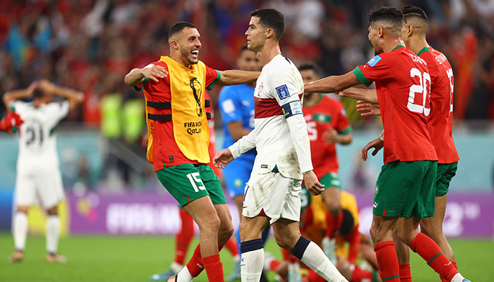 Soccer Football - FIFA World Cup Qatar 2022 - Quarter Final - Morocco v Portugal - Al Thumama Stadium, Doha, Qatar - December 10, 2022 Portugals Cristiano Ronaldo looks dejected after being eliminated from the World Cup as Morocco players celebrate qualifying for the semi finals. — Reuters