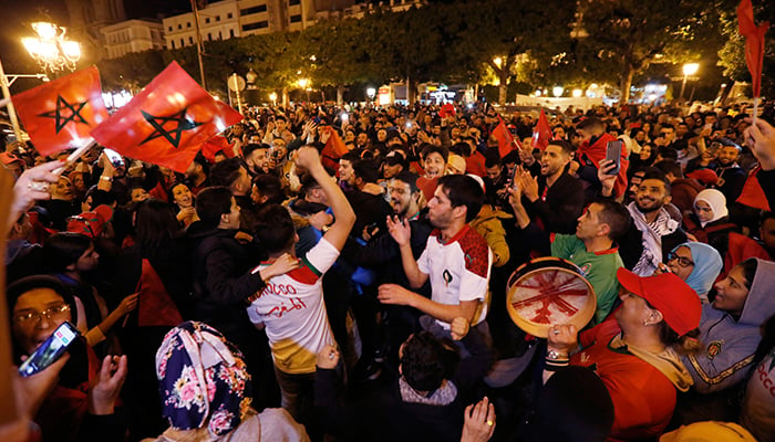 Soccer Football - FIFA World Cup Qatar 2022 - Fans gather in Brussels for Morocco v Portugal - Brussels, Belgium - December 10, 2022 Morocco fans celebrate after the match as Morocco progress to the semi finals. — Reuters