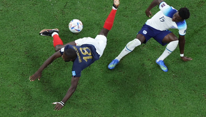 Englands forward #17 Bukayo Saka fouls Frances defender #18 Dayot Upamecano during the Qatar 2022 World Cup quarter-final football match between England and France at the Al-Bayt Stadium in Al Khor, north of Doha, on December 10, 2022.AFP