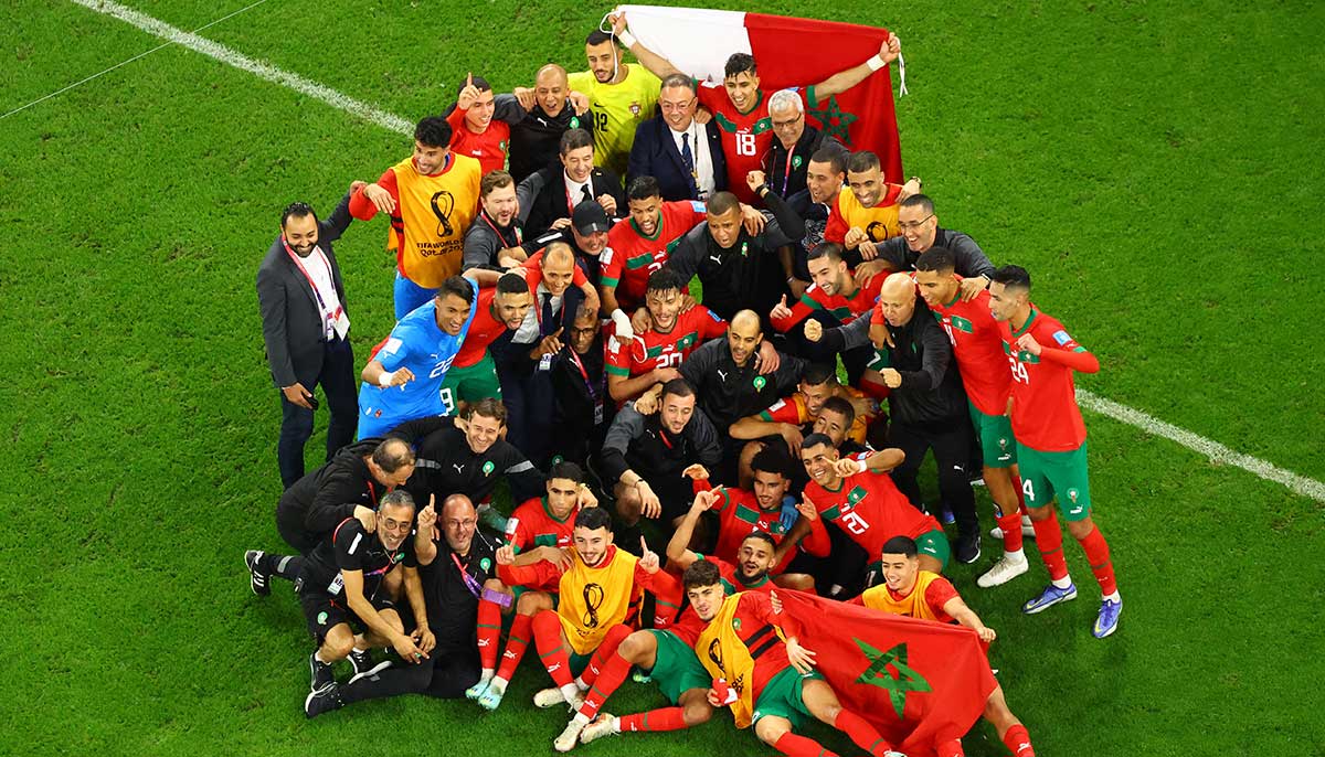 Morocco team members pose for a group photo and celebrate after the match as Morocco qualify for the semi-finals on December 10, 2022. — Reuters