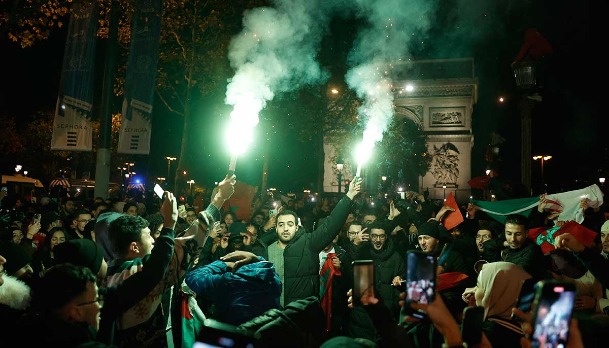 Soccer lovers celebrate with flares by the arc de triomphe in Paris. — Reuters