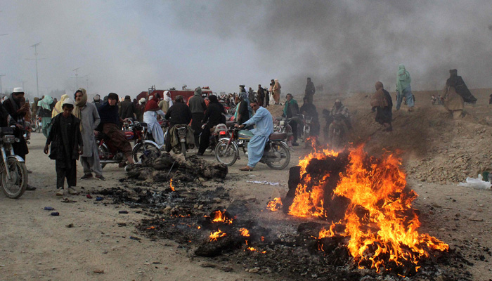 Residents gather after Taliban forces fired mortars at Pakistans border town of Chaman on December 11, 2022. —AFP