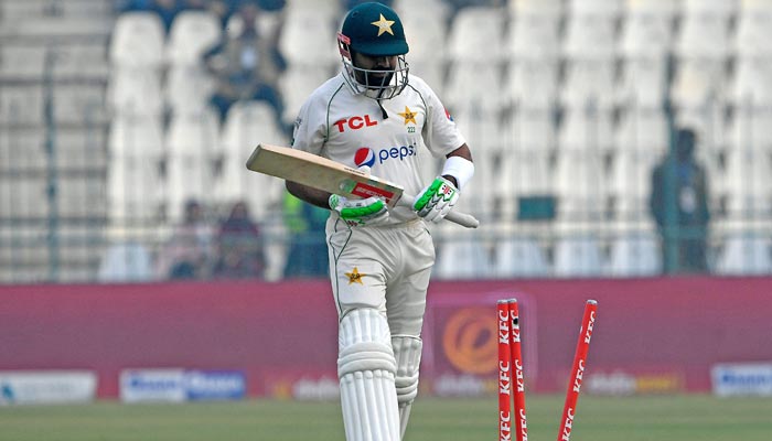 Pakistan´s captain Babar Azam walks back to pavilion after his dismissal during the second day of the second cricket Test match between Pakistan and England at the Multan Cricket Stadium in Multan on December 10, 2022. — AFP