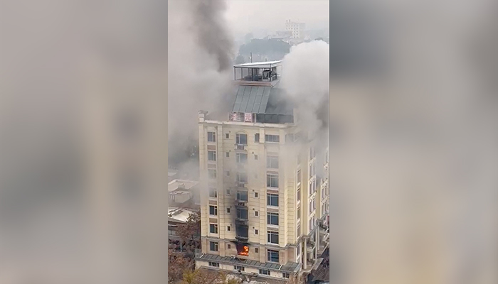 View of a hotel fire in Shahr-e-Naw neighbourhood where gunfire was also heard in Kabul, Afghanistan December 12, 2022, in this still image from a social media video. — Reuters