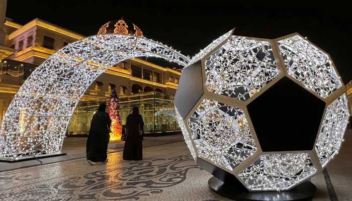 People walk past an illuminated soccer ball ahead of the FIFA 2022 World cup soccer tournament at Katara Cultural Village in Doha, Qatar November 15, 2022. — Reuters