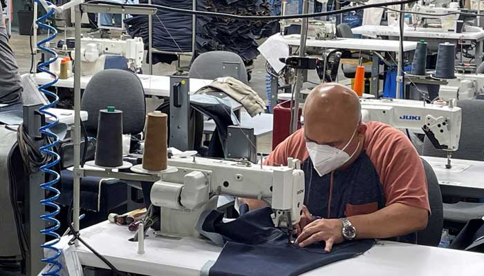 A worker sews blue jeans at Saitexs factory in Los Angeles, California, U.S. September 21, 2022. — Reuters