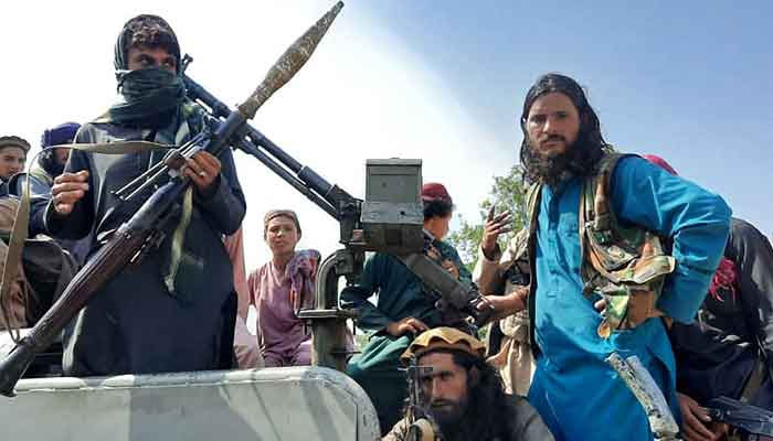 Taliban fighters sit over a vehicle on a street in Laghman province on August 15, 2021. — Photo by AFP